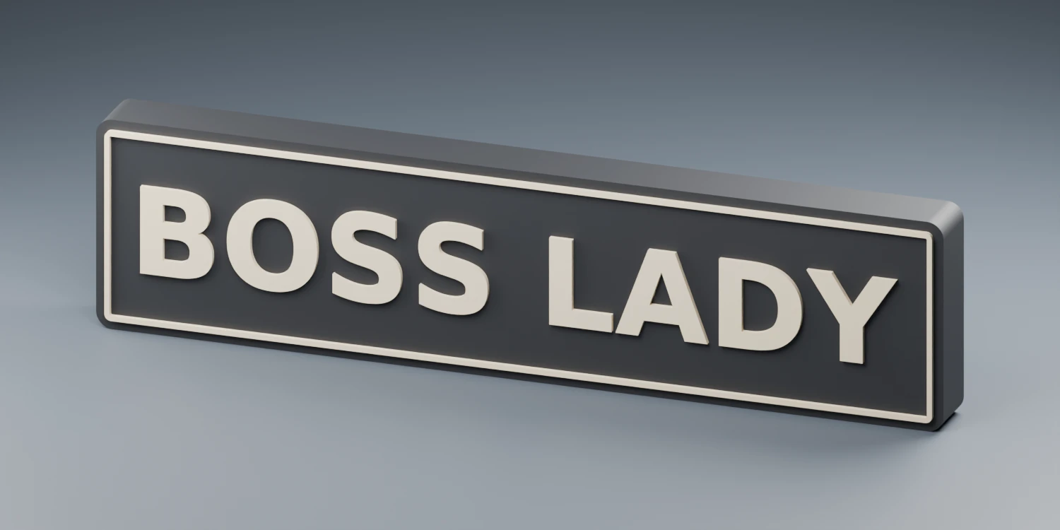 Design rendering of a black BOSS LADY desk sign with raised cream lettering and a matching outline border